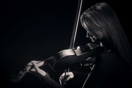 Violin player. Violinist classical musician playing violin music instrument.の写真素材