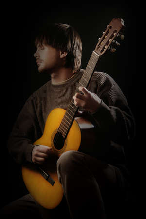 Acoustic guitar player. Classical guitarist playing guitar spanish isolatedの写真素材