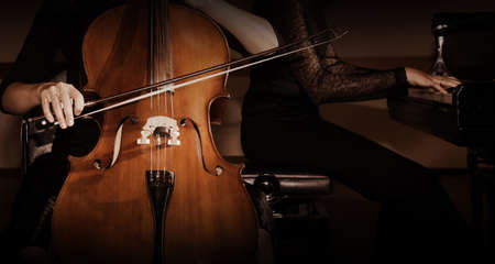Cello and piano players. Duet of cellist and pianist playing ensemble. Classical music instruments...