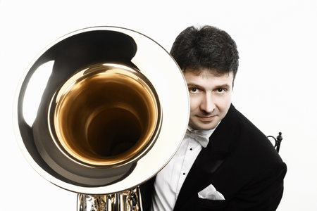 Tuba player brass instrument. Classical musician portrait with musical euphonium trumpet hornの写真素材