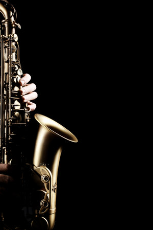 Saxophone player. Saxophonist with sax close up. Jazz music instrumens isolated on black backgroundの写真素材
