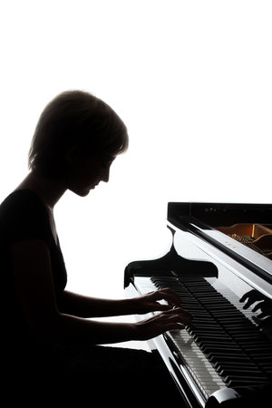 Piano player. Pianist woman playing grand piano Classical musician close upの写真素材