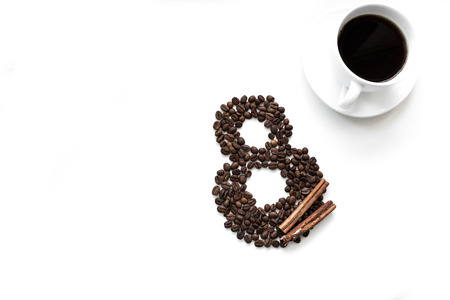 Woman day 8 march with  coffee beans, cinnamon and a cup of coffee on a white backgroundの写真素材