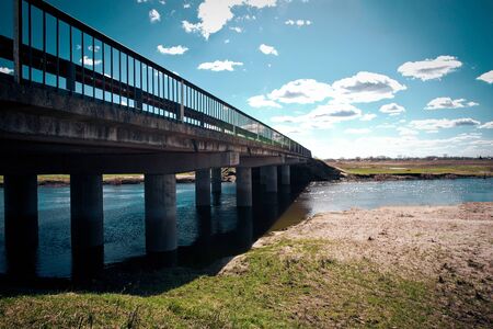 The bridge in the field through a stream.の写真素材