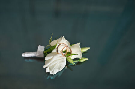 Ornaments for the groom and wedding rings on a glass table.の写真素材