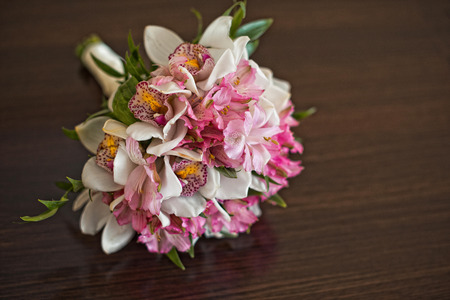 Bouquet from roses and other flowers on a table.の写真素材