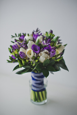 Bouquet from roses and other flowers on a table.の写真素材