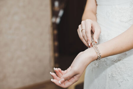 The woman dresses on a hand a bracelet and clasps it.の写真素材