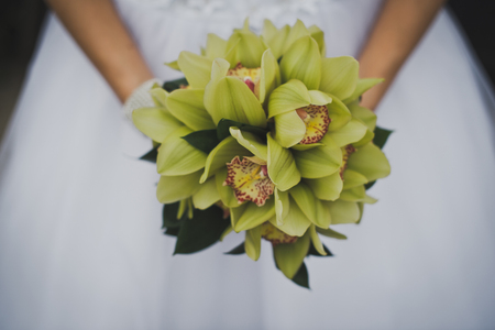 Bouquet of beautiful flowers in hands of the bride.の写真素材