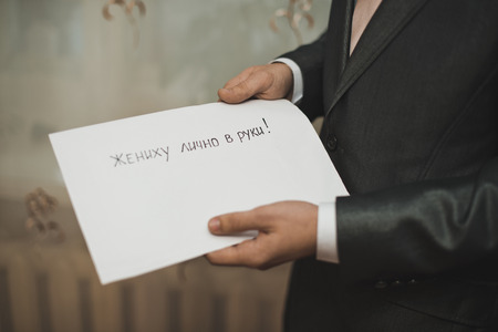 The letter from the cut-out letters in hands of the man.の写真素材