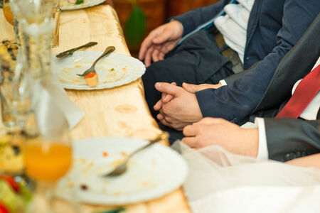 Hands of people with full glasses in movement to each other.の写真素材