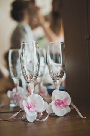 Glasses with pink bows on stand about a mirror.の写真素材