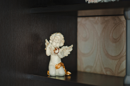 Ornaments hang on small figures of an angel.の写真素材