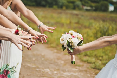 Hands of the woman hold a bunch of flowers.の写真素材