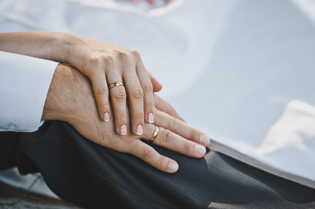 Young gently hold each other by hands.の写真素材