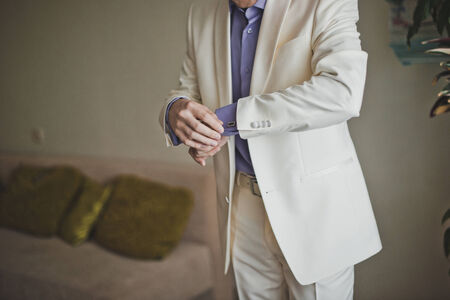 The groom dresses white jacket.