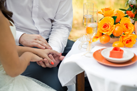 Hands of the newly-married couple embrace each other.の写真素材