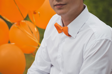 Breast of the young man dressed in a shirt and a butterfly.の写真素材