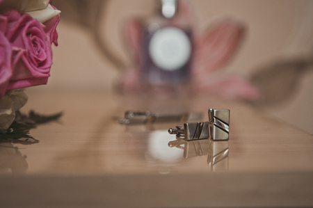 Cuff links for a shirt lie on a table.