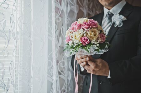 Flowers in hands of the man.の写真素材