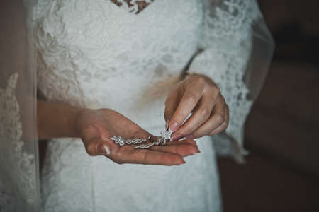 The bride holds earrings.の写真素材