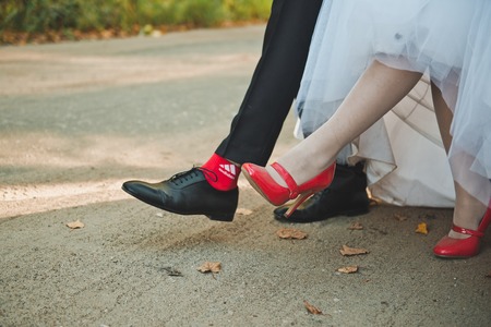 Feet of the newly-married couple in the course of walking.