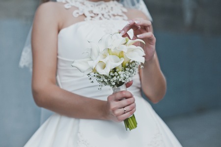 The girl holds a bunch of flowers.の写真素材