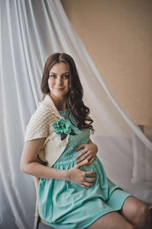 The girl during pregnancy in a beautiful dress.の写真素材