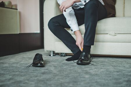 The young man dresses boots.の写真素材