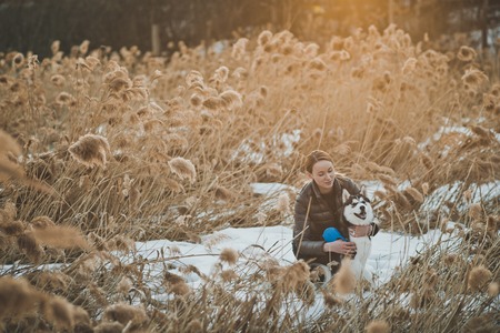 Walk of the girl with a dog in the spring.の写真素材