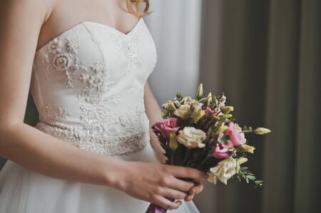 The girl holds a bunch of flowers.の写真素材