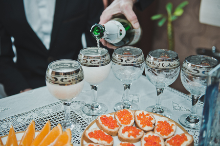 The person pours champagne in glasses.の写真素材