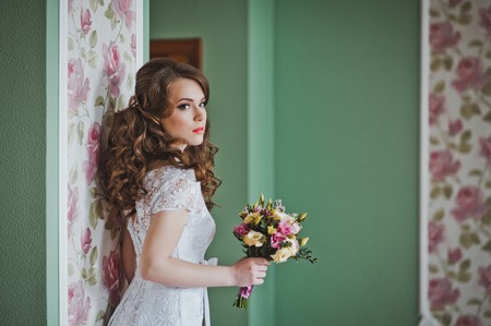 The girl with a bouquet indoors.の写真素材