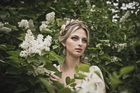 Portrait of the girl in blossoming bushes.の写真素材