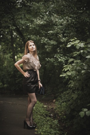 The red girl among leaves.の写真素材