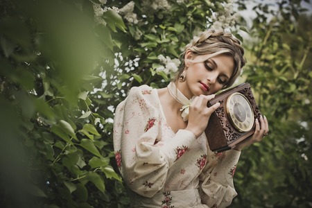 The girl in flowers of a cherry.の写真素材