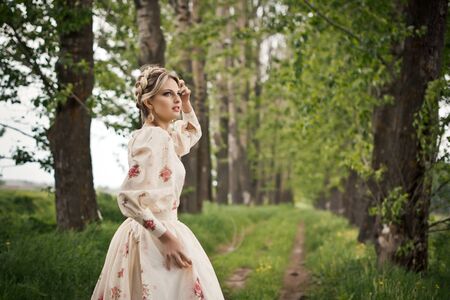 The girl in a dress with flowers.の写真素材