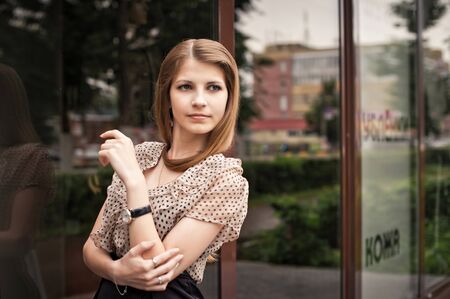 The girl at a glass wall.の写真素材
