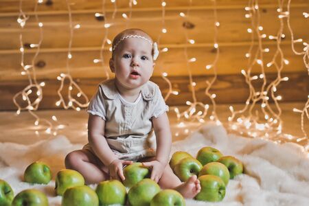 The girl sits on a carpet.の写真素材