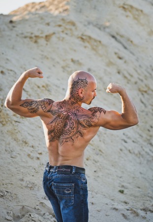 The brutal man with a tattoo.の写真素材