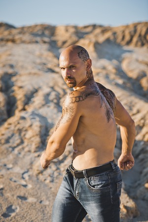 Naked torso of the brawny man with a tattoo.の写真素材