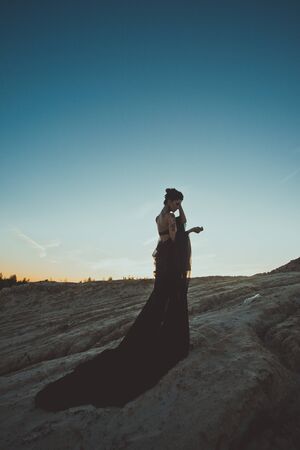 The girl with a developing fabric at sunset.の写真素材