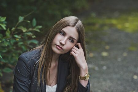 Girl sitting near the Bush.の写真素材