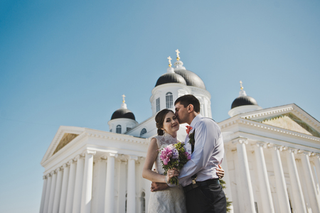 The couple are standing in front of the white columns.の写真素材