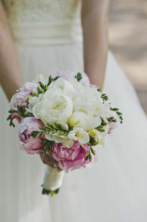 A girl holds a bouquet.の写真素材