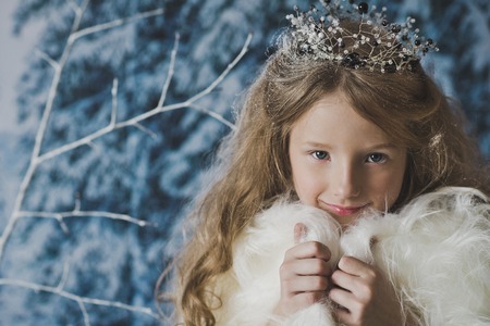 Portrait of the snow Queen in the winter woods.