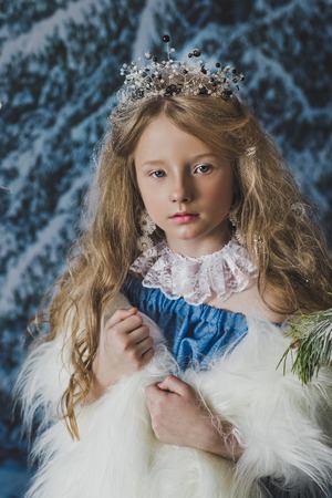 Portrait of the snow Queen in the winter woods.の写真素材