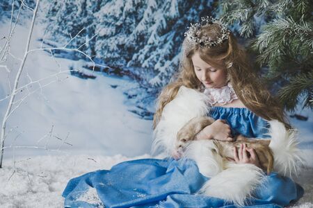 Portrait of the snow Queen in the winter woods.の写真素材