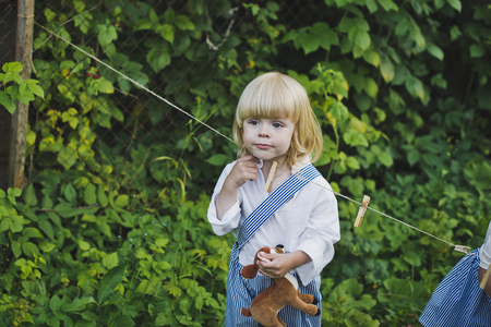 The boy with the white hair in the background of the Bush.の写真素材