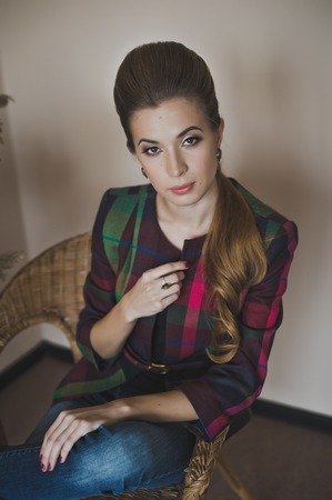 Girl in a wicker chair in the Studio.の写真素材